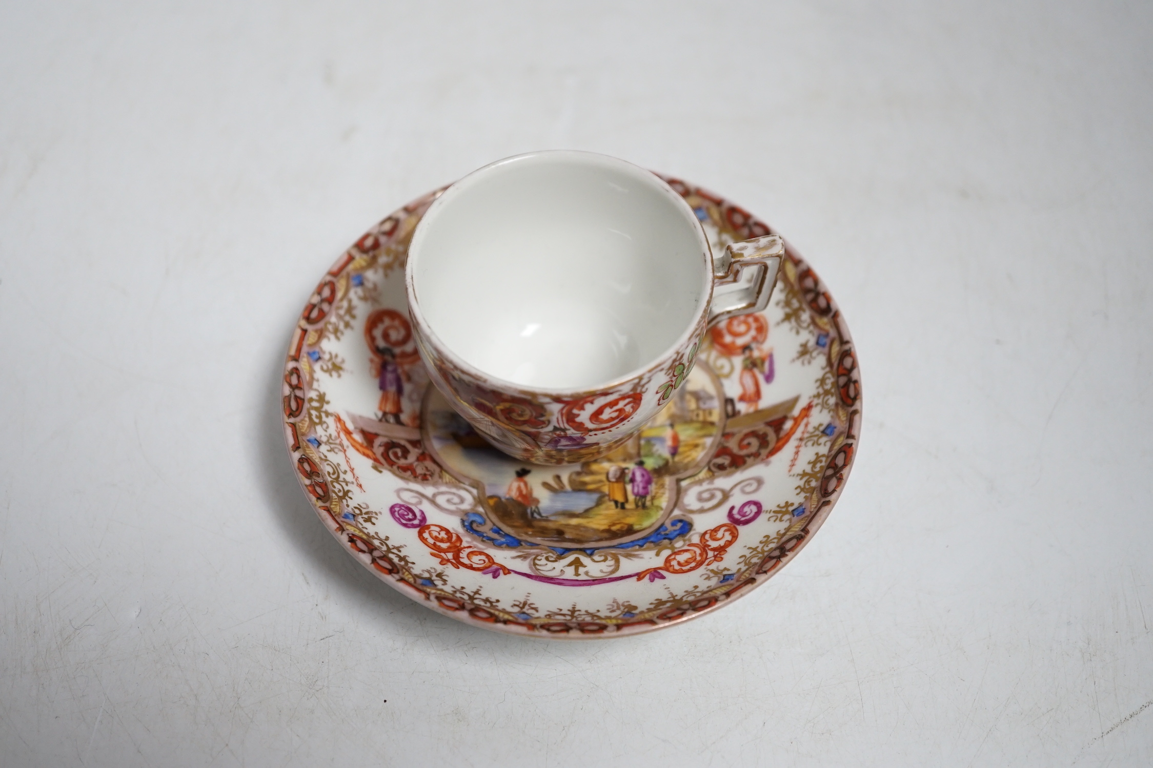 A miniature Dresden teacup and saucer in Meissen-style, cup 4.5cm